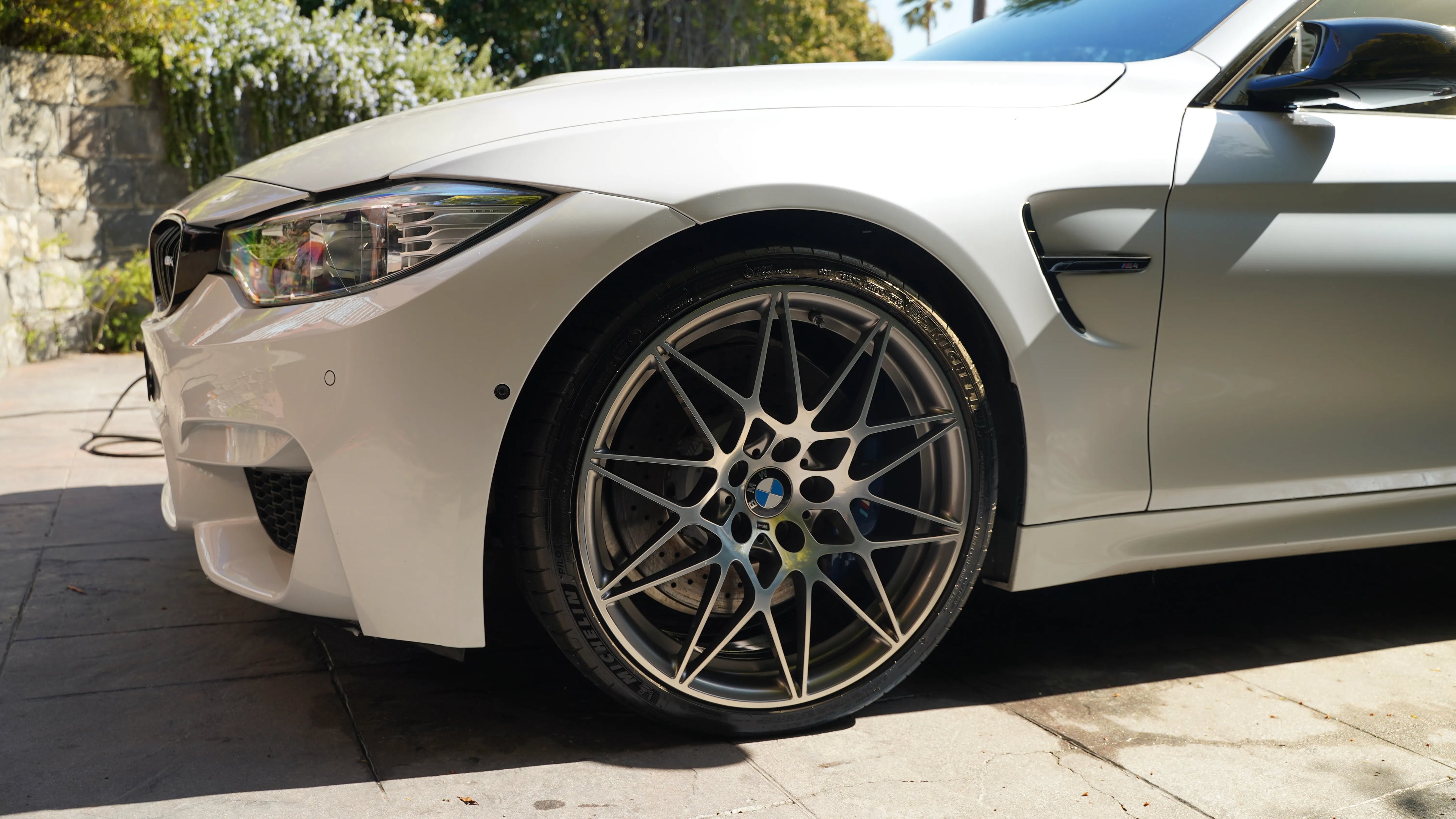 BMW M4 detailed by NovaLux Auto Detailing in 2024, showing clean, polished wheels and a pristine exterior.