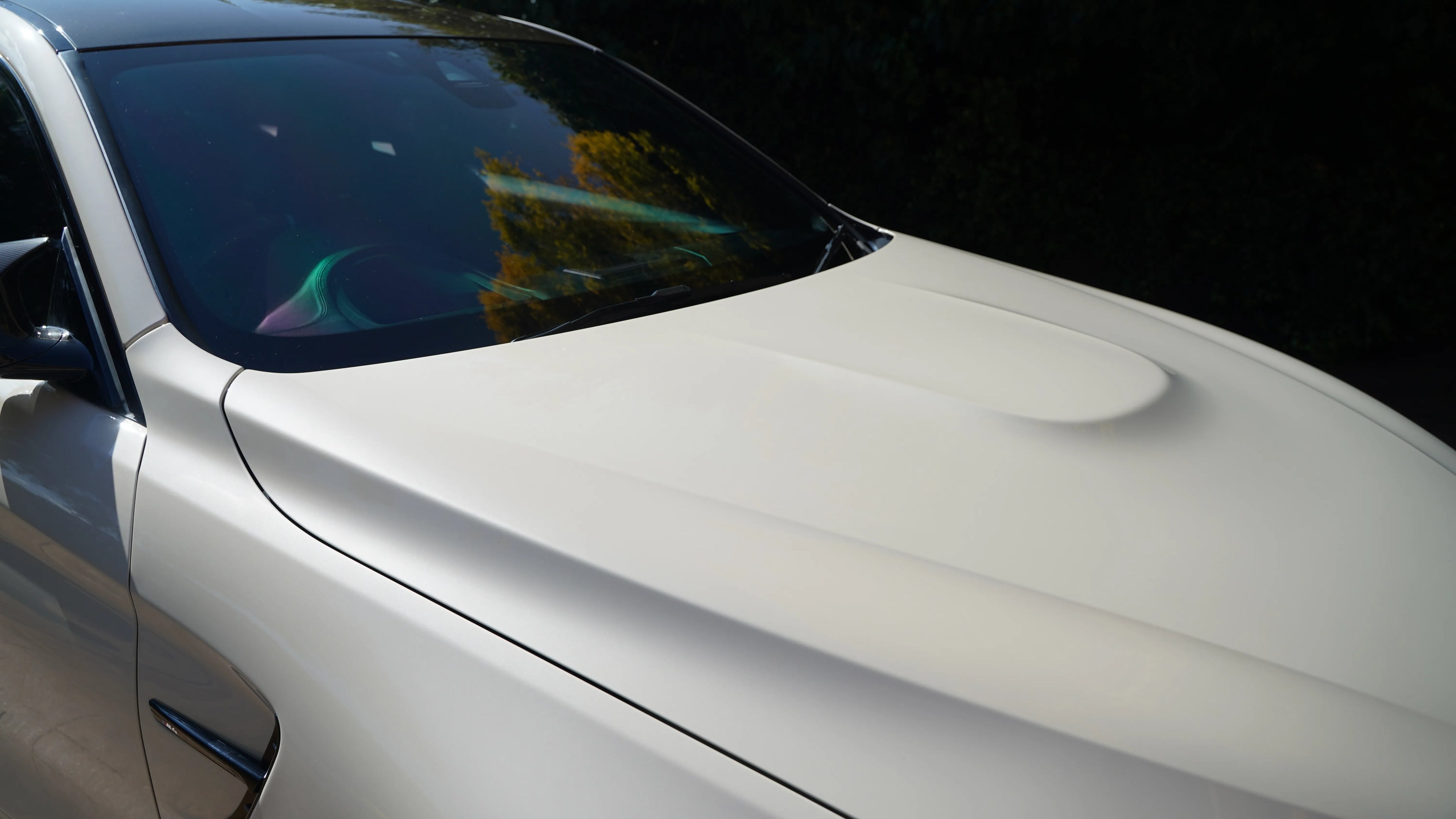 BMW M4 exterior cleaned by NovaLux Auto Detailing in 2024, highlighting a spotless and polished hood and windshield.