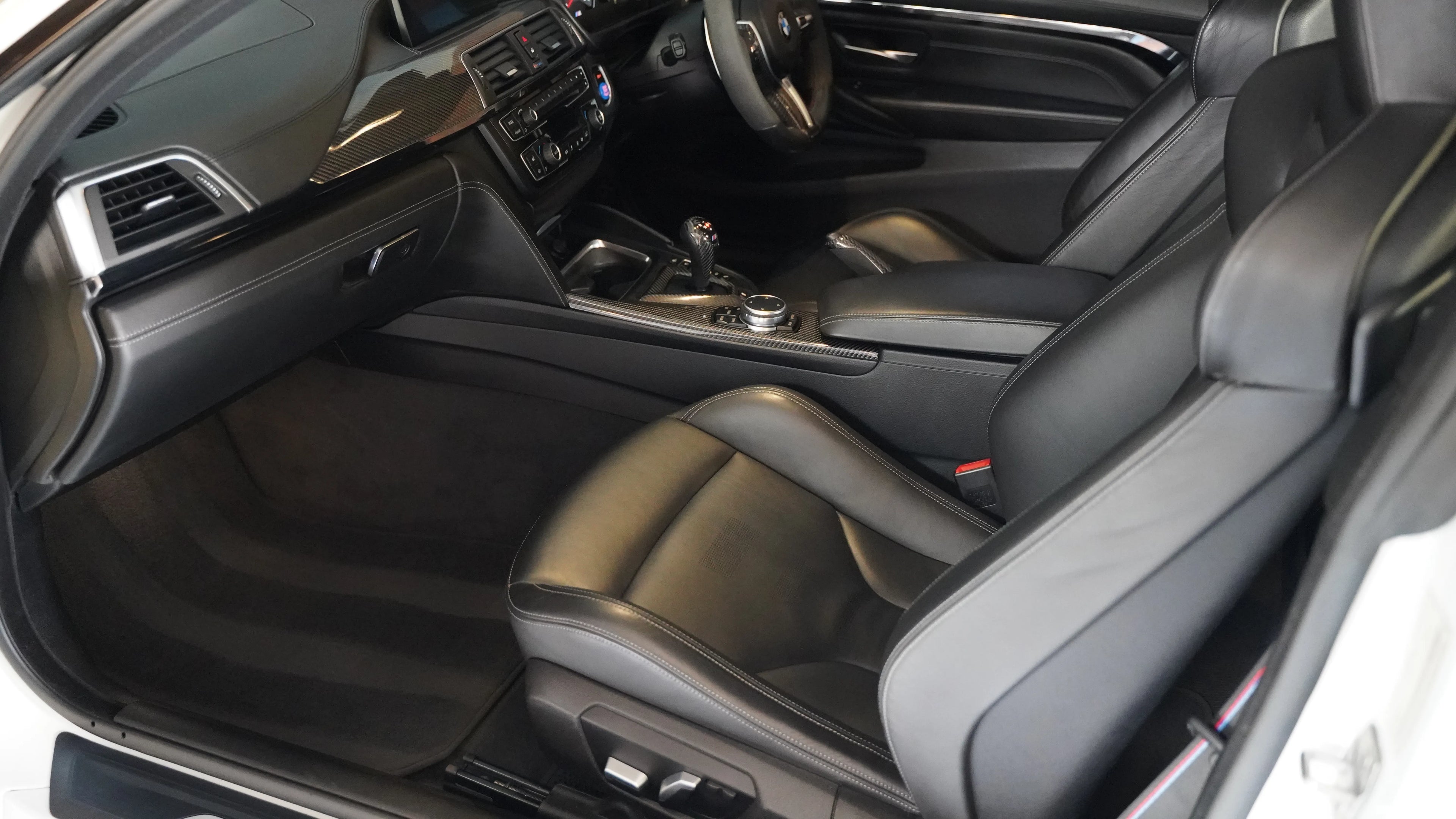 Clean and polished BMW M4 interior after a professional detailing by NovaLux Auto Detailing in 2024.